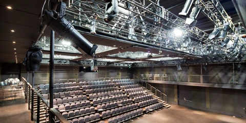 Empty Studio Underground theatre with rows of tiered seating and overhead lighting equipment.