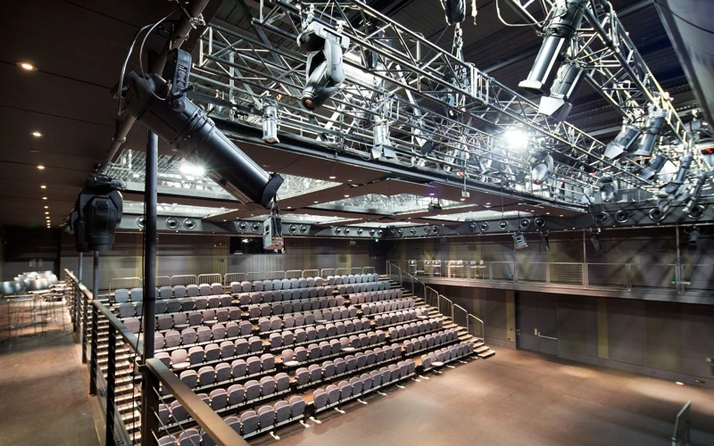 Studio Underground Empty Studio Underground theatre with rows of tiered seating and overhead lighting equipment.