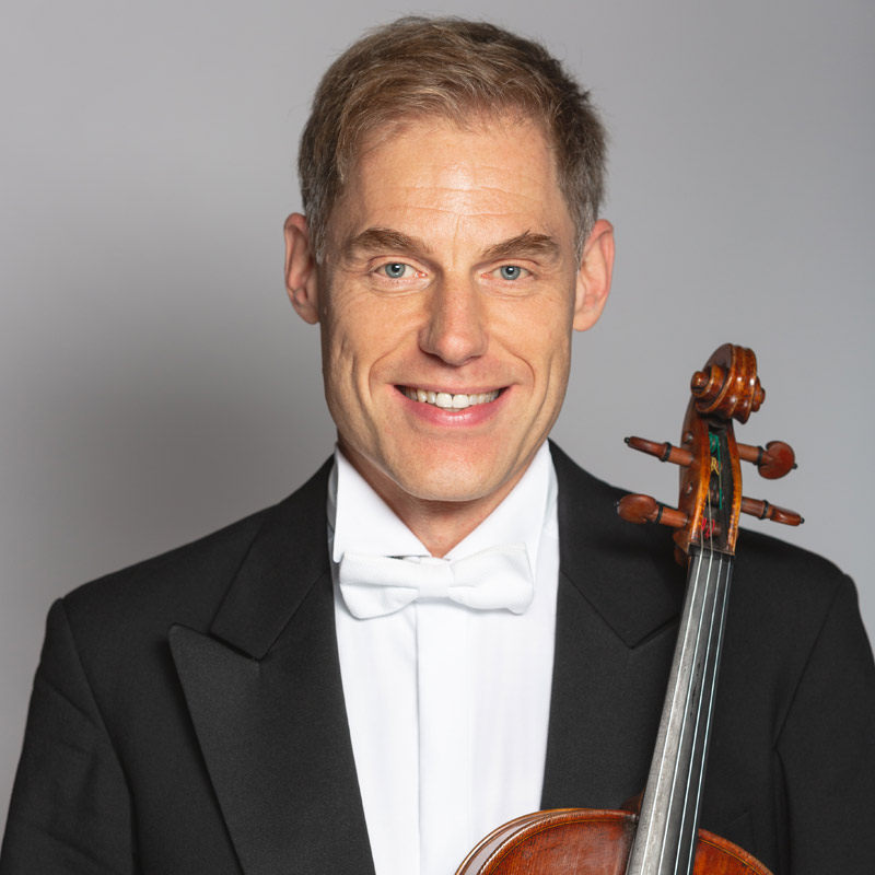 Daniel Schmitt holding a viola