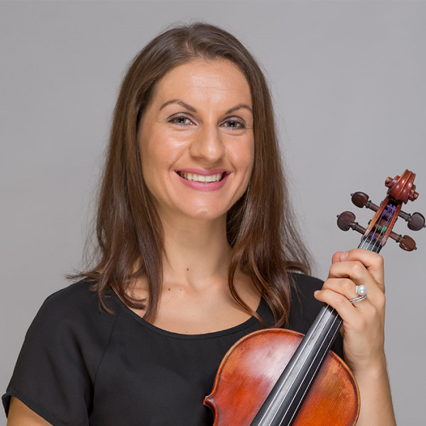 Christina Karsimbardis holding a violin