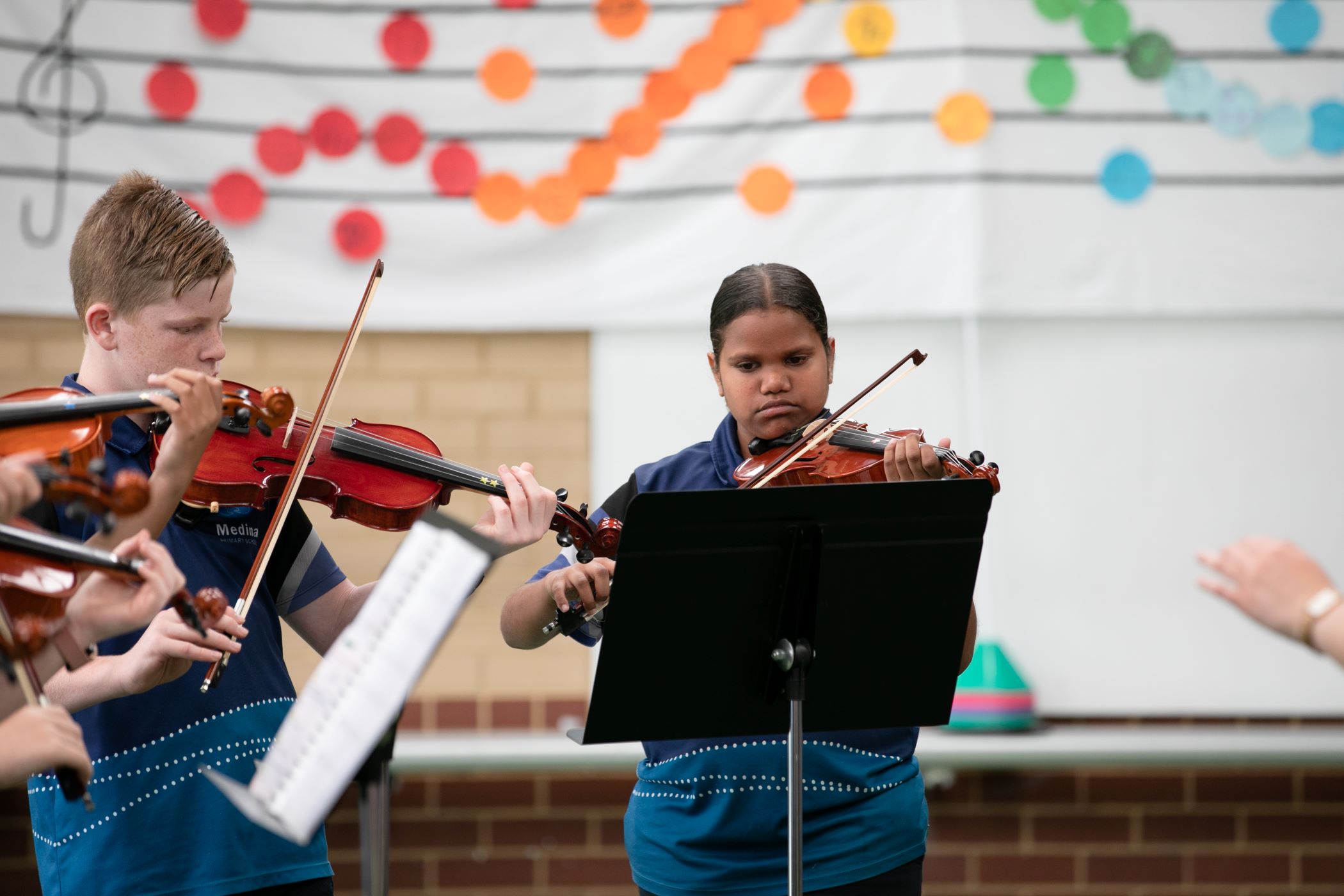 Sandra Hart and other Crescendo students from Medina Primary School playing violin at their End of Year Concert.