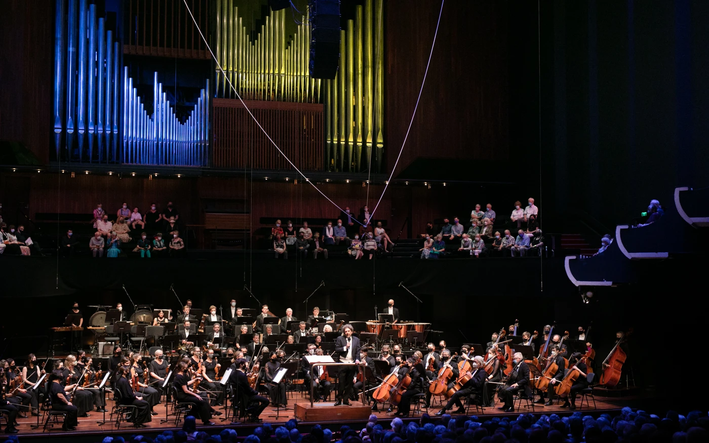 WASO sit on stage as conductor Asher Fisch addresses audience at Perth Concert Hall.
