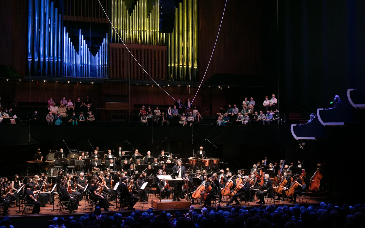 WASO sit on stage as conductor Asher Fisch addresses audience at Perth Concert Hall.