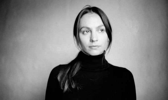 Black & white headshot of Olivia Davies wearing a black turtleneck.