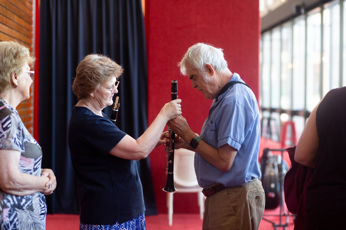 Two people inspect a clarinet