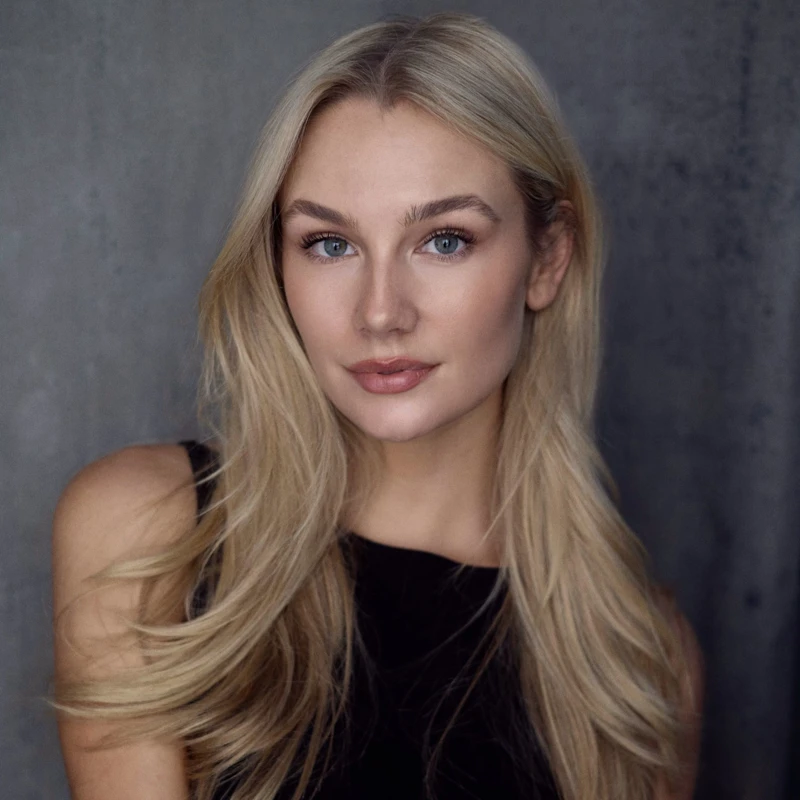 Headshot of Amy Manford wearing a black sleeveless top.