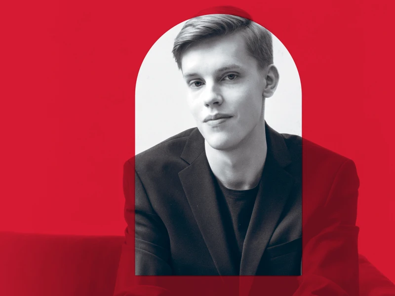 A promotional image of a conductor with a red overlay, red aligns with the branding for the 2026 MACA Symphonic Series