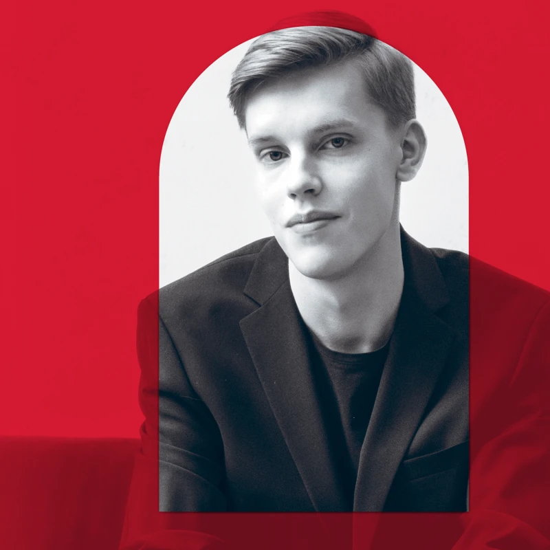 A promotional image of a conductor with a red overlay, red aligns with the branding for the 2026 MACA Symphonic Series