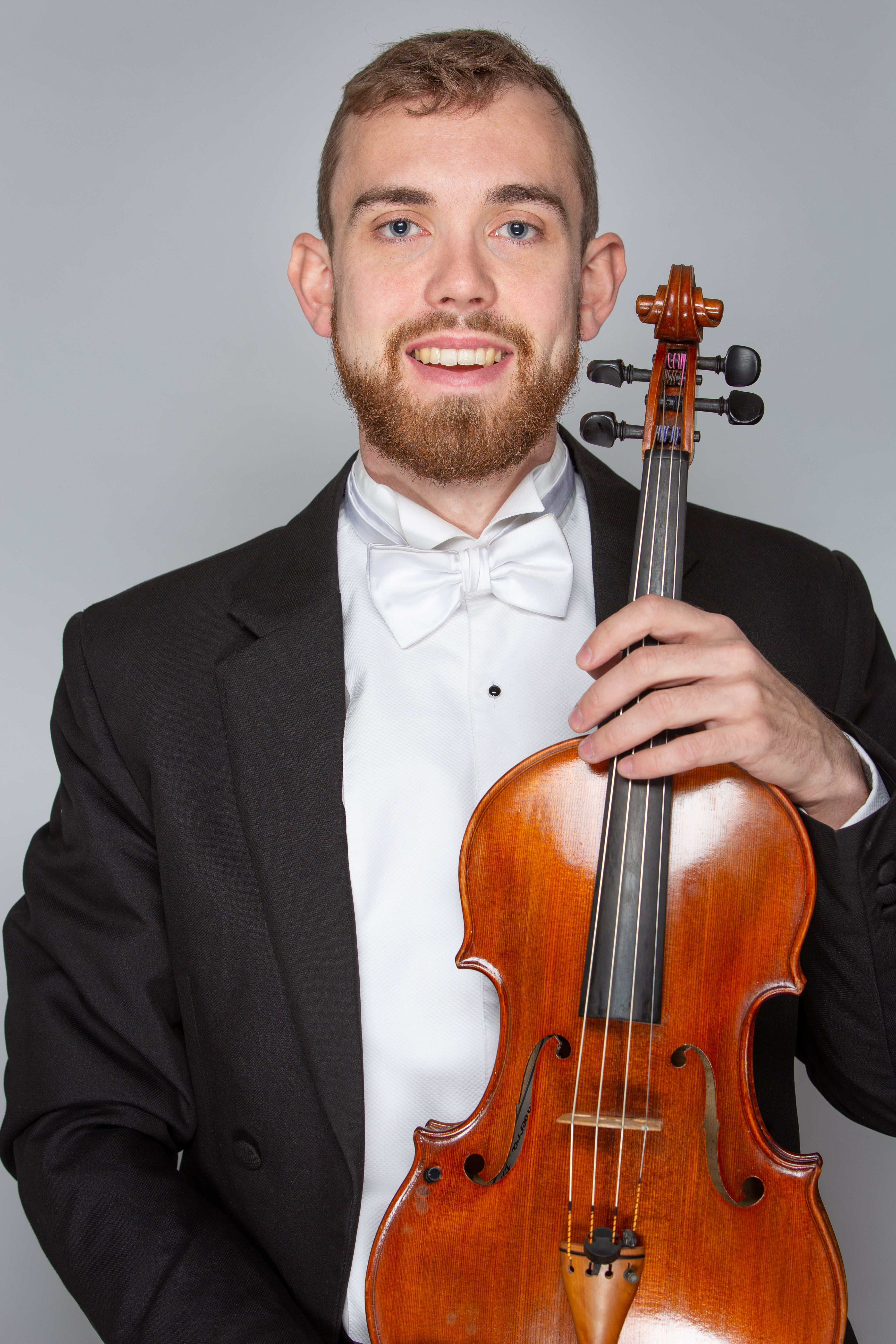Elliot O'Brien holding a viola