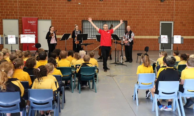 Presenter Lee Stanley and WASO's four-piece Education Chamber Orchestra perform for a group of primary school students.