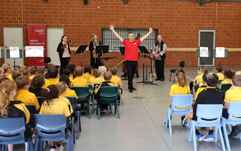 Presenter Lee Stanley and WASO's four-piece Education Chamber Orchestra perform for a group of primary school students.