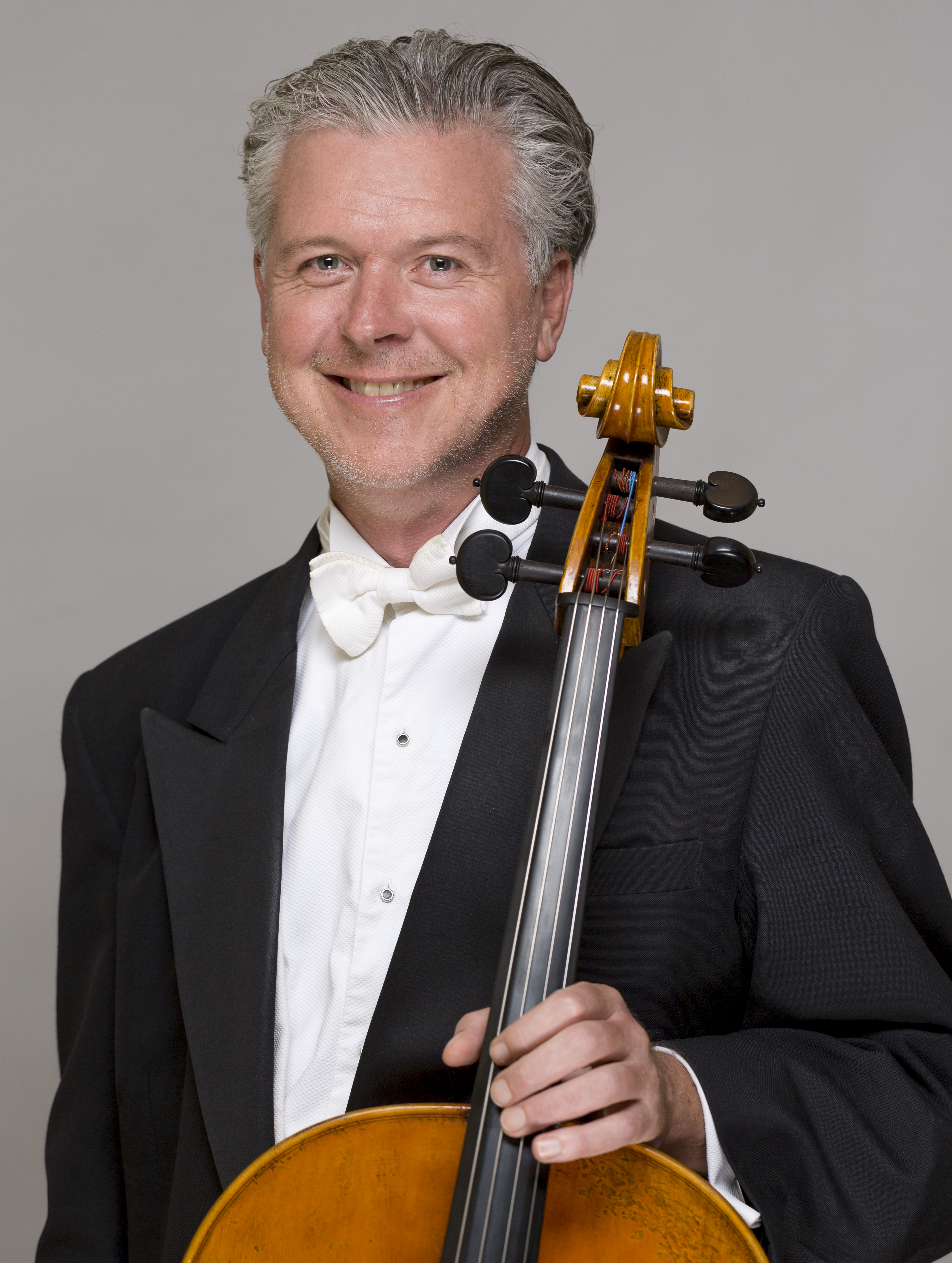 Oliver McAslan holding his cello