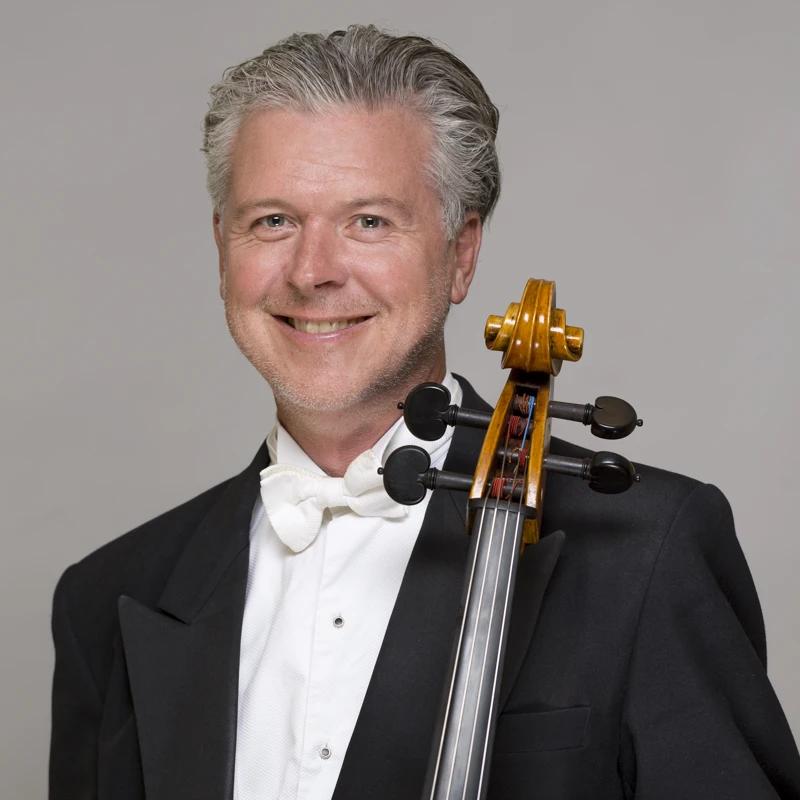 Oliver McAslan holding his cello