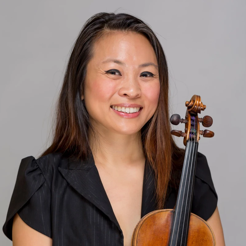 Headshot of Semra Lee wearing a black top, holding a violin.
