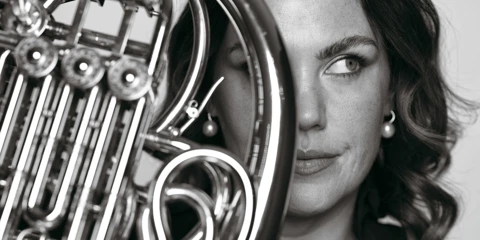 A creatively cropped promotional image of horn player Julia Brooke