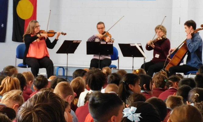 A WASO string quartet performs for a group of primary school students.