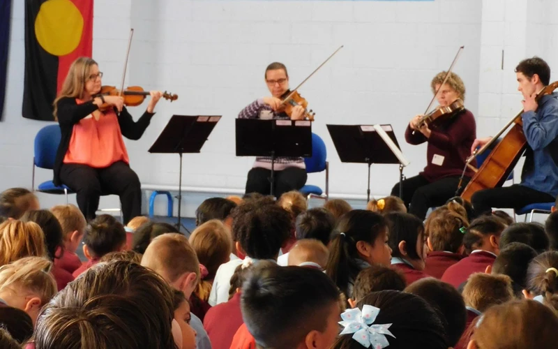 A WASO string quartet performs for a group of primary school students.